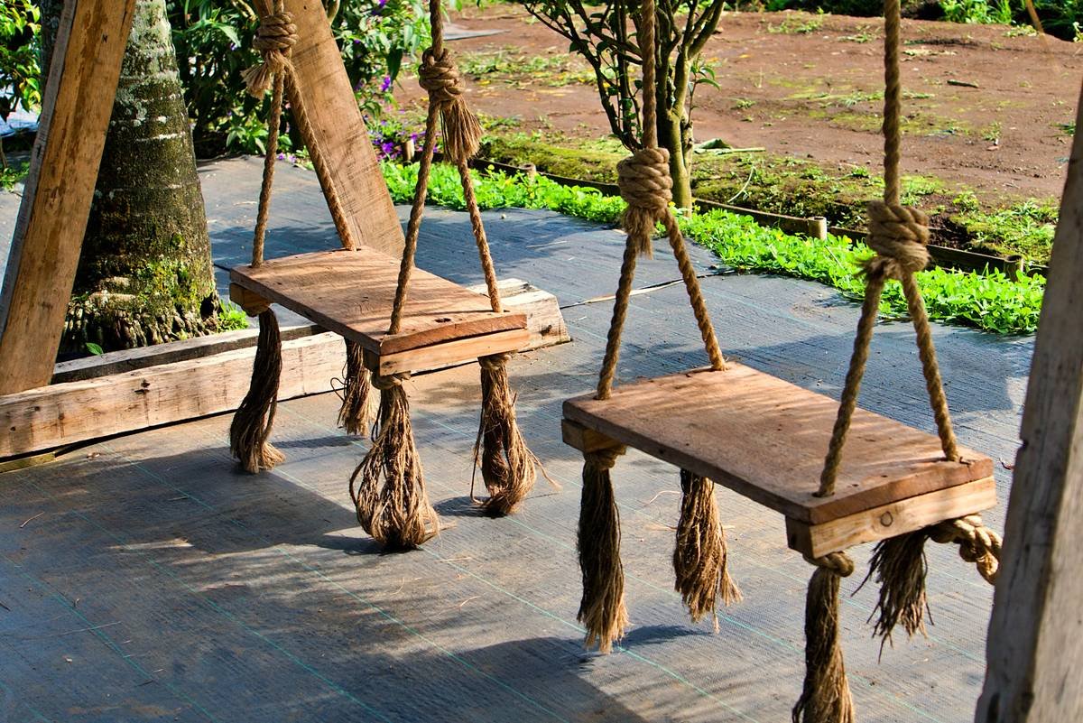 11 Wooden Outdoor Benches That Stand the Test of Time (and Rain)