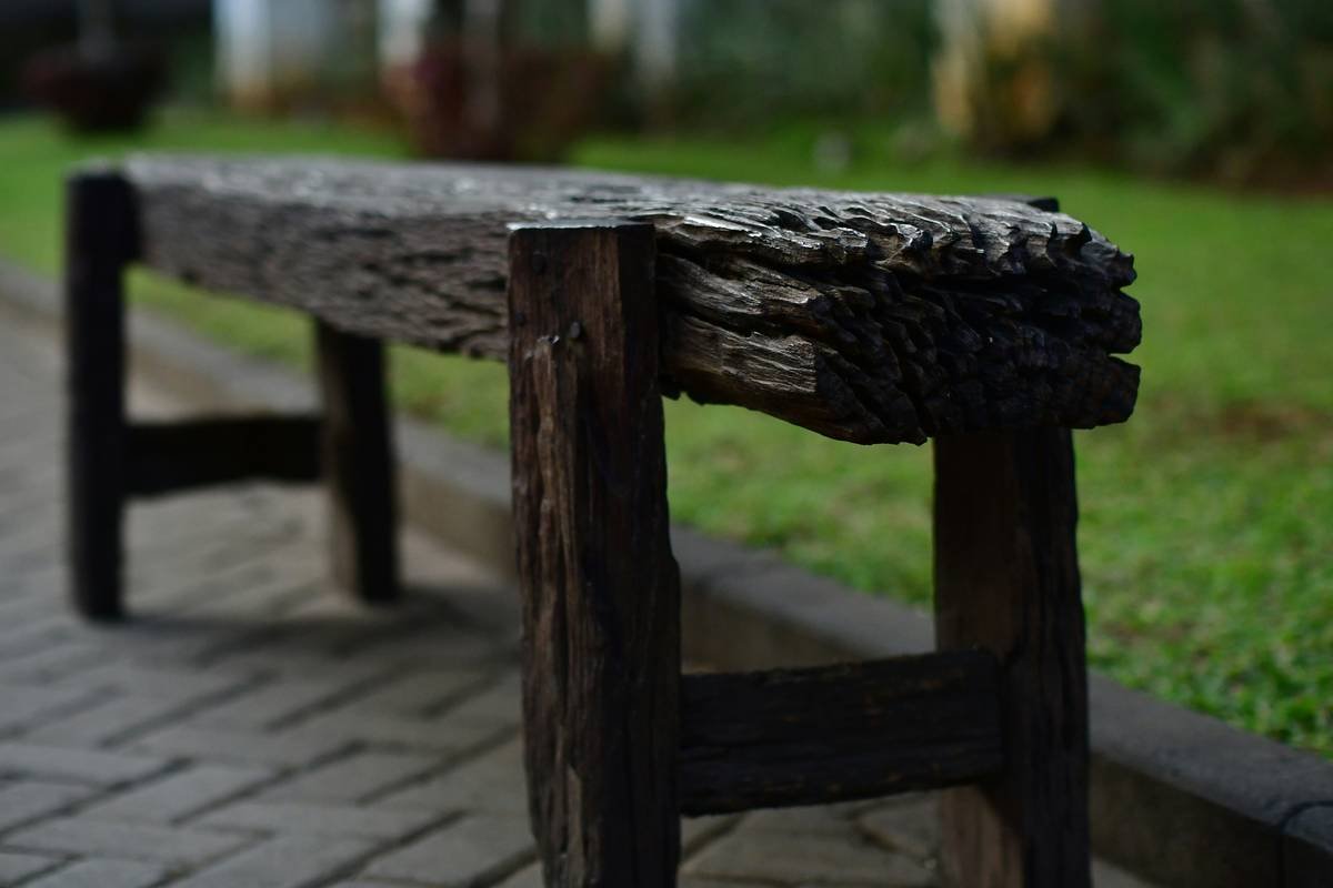 Close-up of weather-resistant garden benches clearance models with price tags slashed