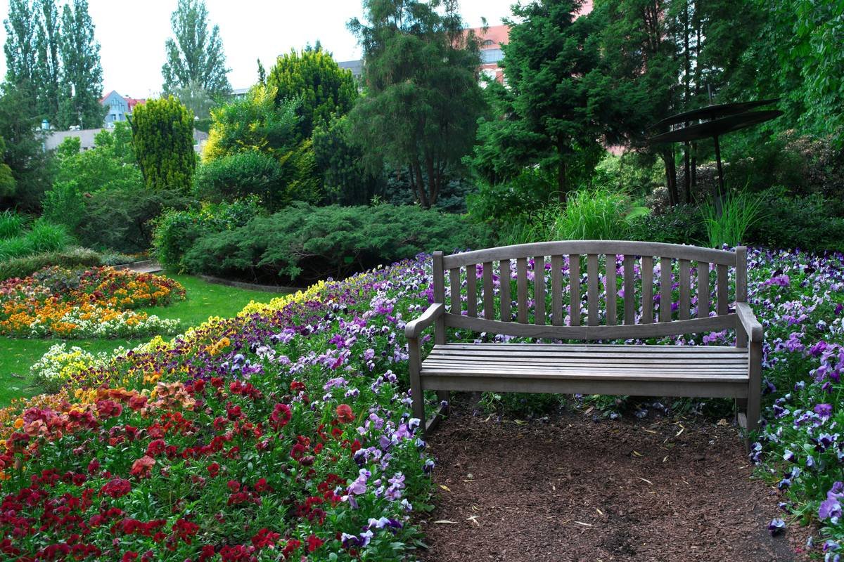 ways with garden benches featuring a weather-resistant teak bench nestled along a flower-lined pathway